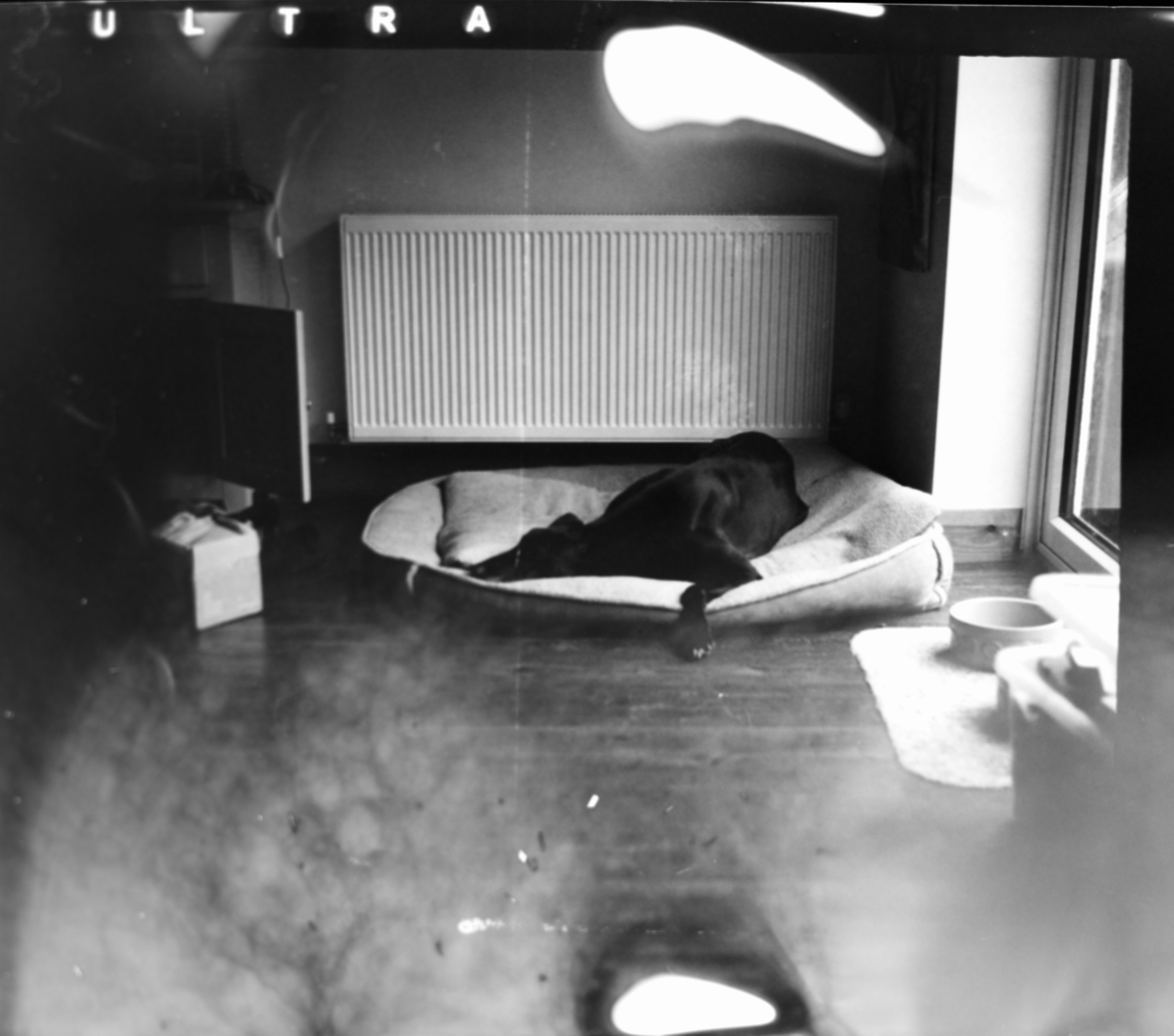 grayscale photo of man lying on bed